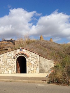 some homes are like hobbit holes -- entrance in the side of hill with chimneys