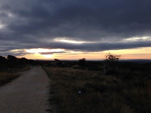 sun coming up over the hills 